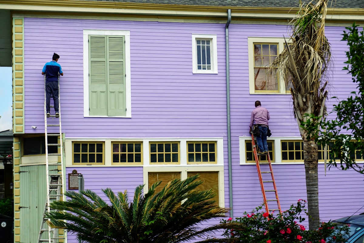 Painting crew working together on an exterior wall