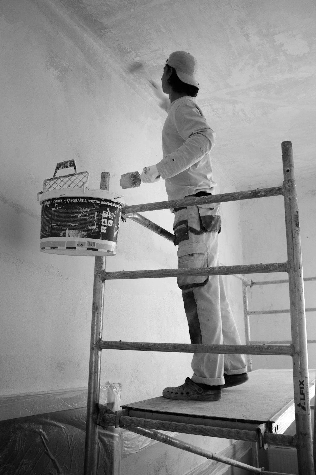 Painter rolling fresh paint onto an interior wall