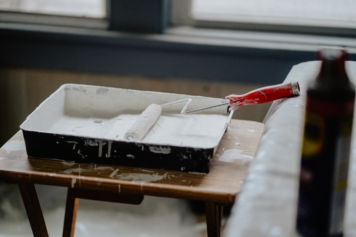 Paint roller and tray loaded with fresh paint